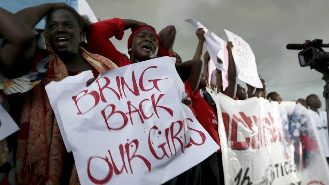 Women react during a protest demanding security forces to search harder for 200 abducted schoolgirls, outside Nigeria's parliament in Abuja