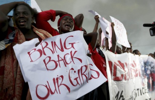 Women react during a protest demanding security forces to search harder for 200 abducted schoolgirls, outside Nigeria's parliament in Abuja