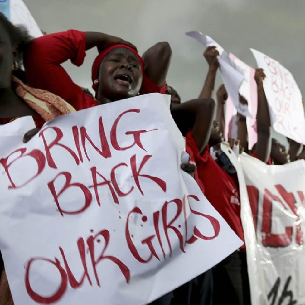 Women react during a protest demanding security forces to search harder for 200 abducted schoolgirls, outside Nigeria's parliament in Abuja